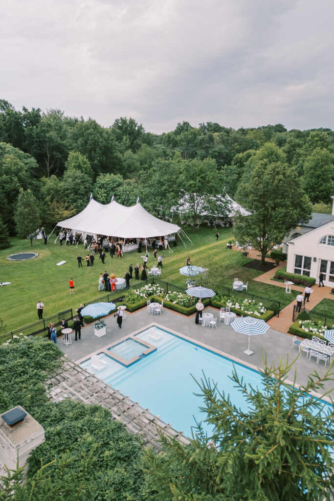 Aerial and scenic views of a luxury tented estate wedding in Ohio, featuring two sailcloth tents, poolside cocktail hour spaces, and detailed outdoor setups planned by an expert Ohio wedding planner.
