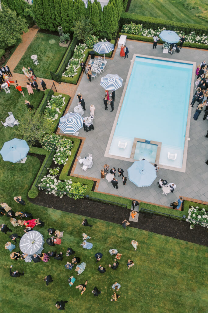 Aerial and scenic views of a luxury tented estate wedding in Ohio, featuring two sailcloth tents, poolside cocktail hour spaces, and detailed outdoor setups planned by an expert Ohio wedding planner.