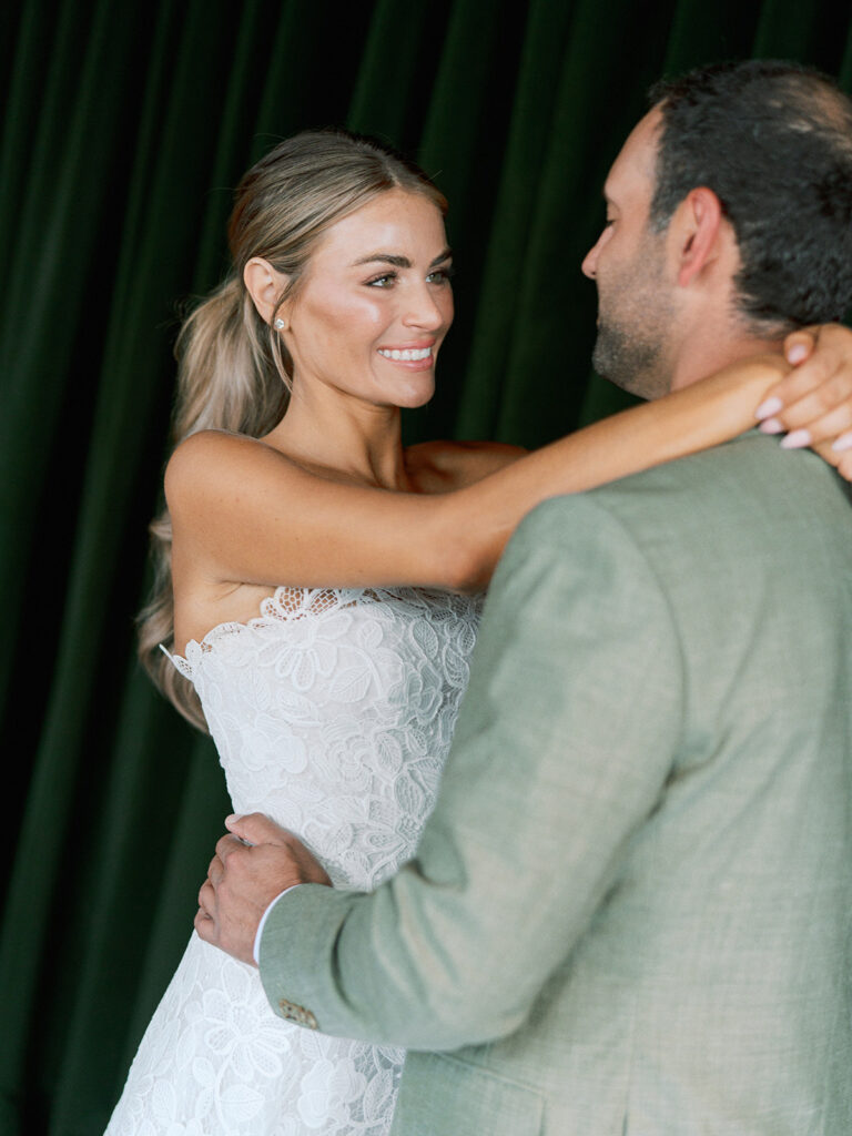 Bride and groom at their Junto Hotel wedding welcome party in Columbus Ohio celebrating at Brass Eye rooftop bar.