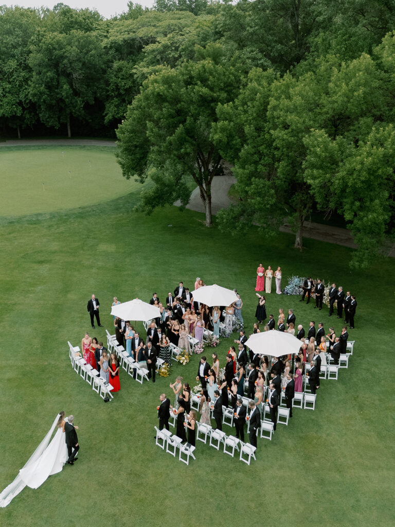 Outdoor ceremony aisle lined with lush pastel florals at New Albany Country Club.