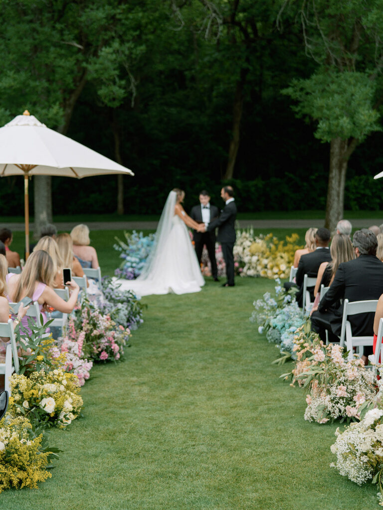 Outdoor ceremony aisle lined with lush pastel florals at New Albany Country Club.