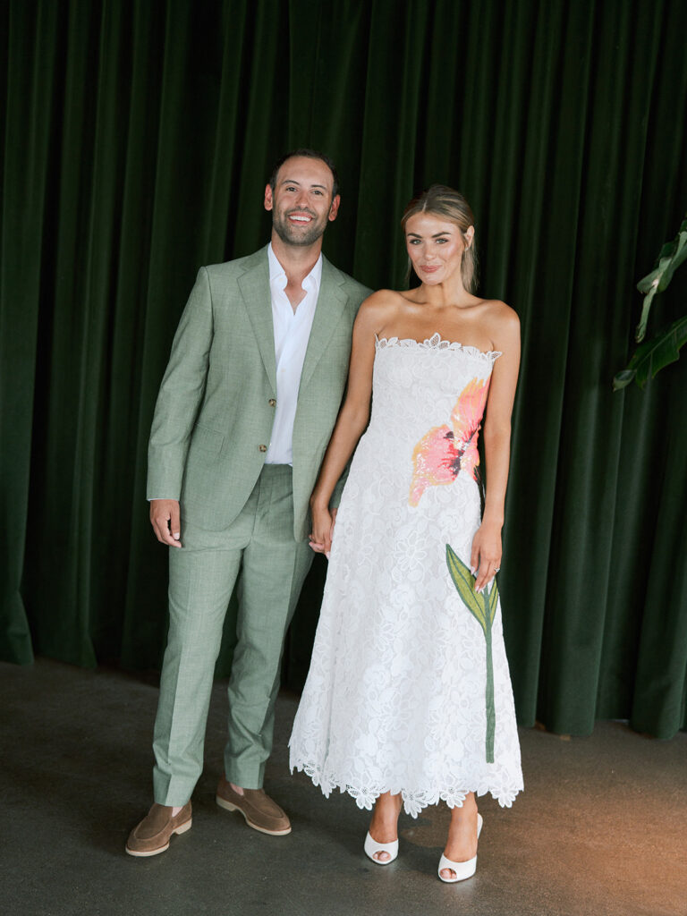 Bride and groom at their Junto Hotel wedding welcome party in Columbus Ohio celebrating at Brass Eye rooftop bar.